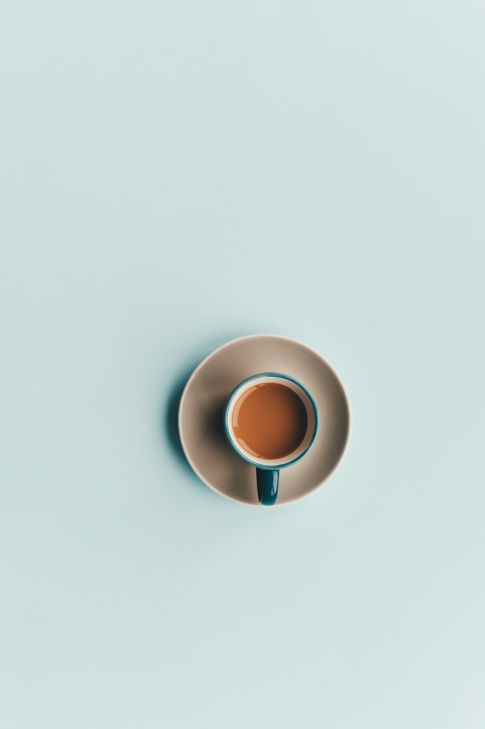 Blue cup and saucer surrounded by a large pale blue background