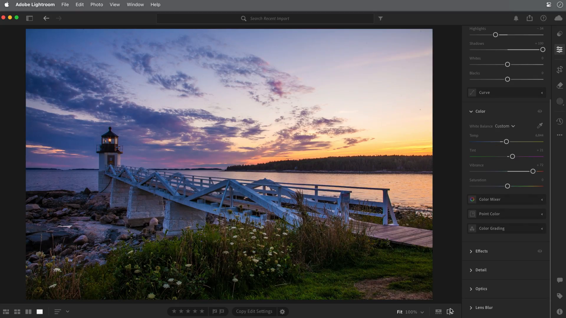 Adobe lighthouse photograph after adjustments, with more visible foreground detail and stronger sunset color