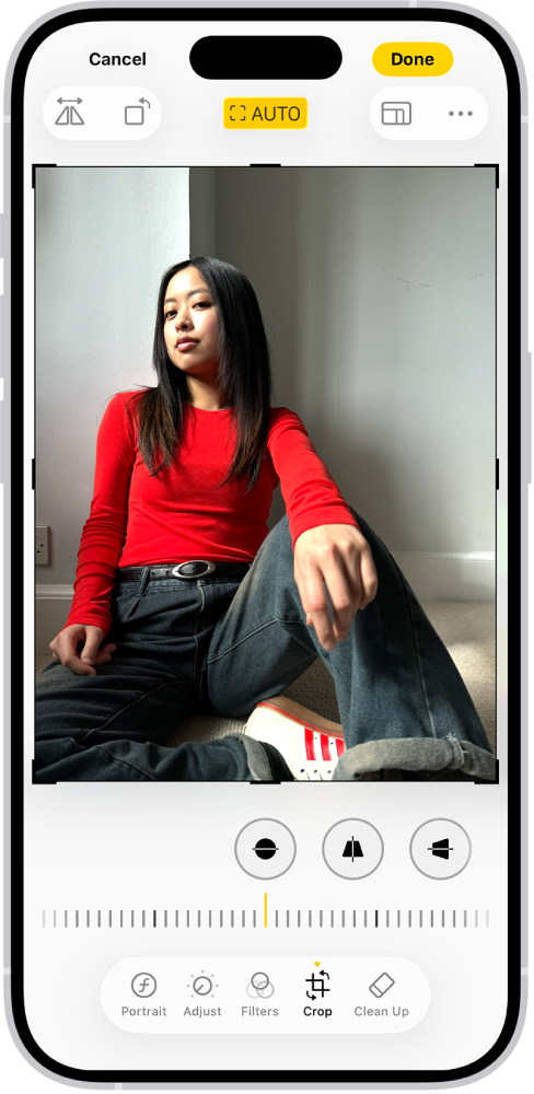 Apple Photos example with a seated portrait, crop corner handles and Straighten selected