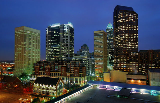 Nikon’s published city-at-dusk example with illuminated buildings beneath a blue sky