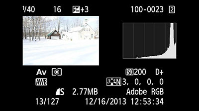 Canon camera playback example with snow preview, plus three compensation and histogram clipped at the right edge